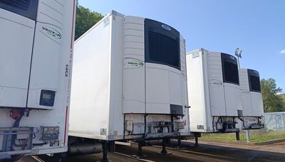 many trucks that are lined up in a parking lot