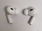 two white airpods sitting on top of a white table next to each other