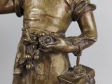 bronze statue of a woman holding a purse and talking on a cell phone