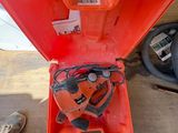 an orange tool box with a chainsaw inside of it