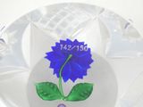 a glass plate with a blue flower on it