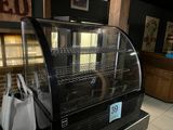 a display case with a bag in front of it