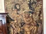 a tapestry hanging on the wall next to a dresser
