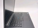 a laptop computer sitting on a table with a keyboard