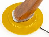 a yellow plate with a wooden handle on top of it