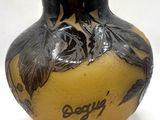 a yellow vase with a black design on it