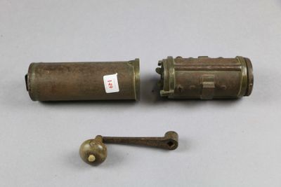 an old brass cylinder and a brass ball on a white surface