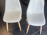 two chairs that are sitting next to each other in a room