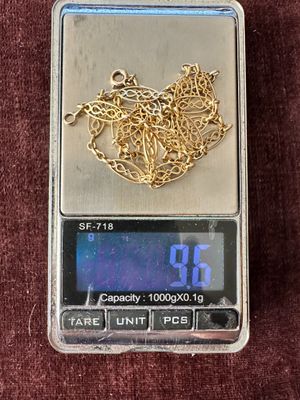 a scale with a gold heart on it on a red cloth