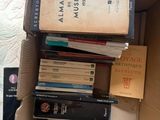 many books stacked on top of each other in a box