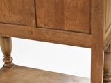 a wooden cabinet with a door on top of it