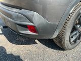 a close up of the rear end of a car with a flat tire