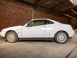 a white car that is parked inside of a building