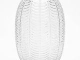 a glass vase that is sitting on a white surface