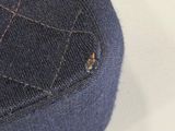 a close up of a piece of denim on a white surface
