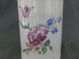 a white container with flowers on it sitting on a table