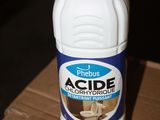 a bottle of acide sitting on a cardboard box