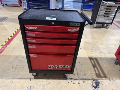craftsman ' s tool box on wheels in a garage with tools in the background