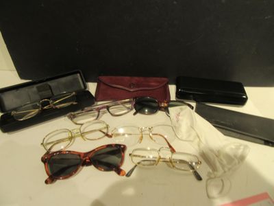 a lot of glasses and a cell phone on a table