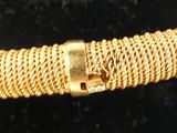a close up of a gold bracelet with a clasp on it