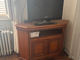 a television on a stand in the corner of a living room