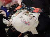 a suitcase full of clothes and other items sitting on a bed