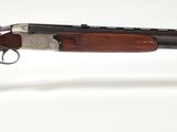 a close up of a rifle on a stand on a white surface