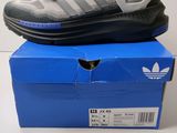 a pair of adidas shoes sitting on top of a blue box