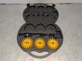 two waffle molds in the shape of sunflowers on a table