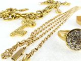 a lot of gold jewelry on a white surface