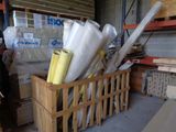 a wooden crate filled with rolls of plastic and other items