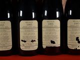 several bottles of wine are lined up on a table