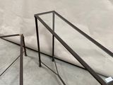 a glass table with a metal frame on it