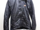 jacket on a hanger on a wall with a white wall in the background