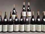six bottles of wine are lined up in a row on a table