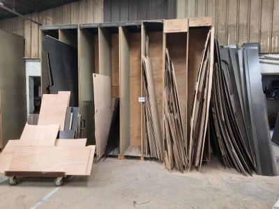many pieces of wood stacked up in a warehouse