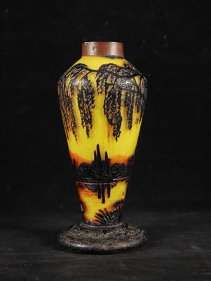 yellow and black vase with palm trees on it against a black background