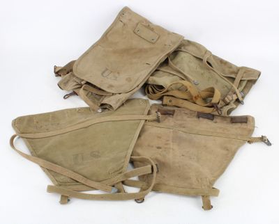 several old military items are sitting on a white surface