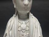 a white statue of a woman with a crown on her head