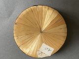 a picture of a round wooden object with a sticker on it