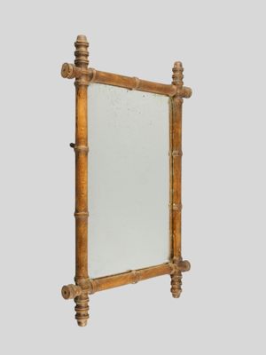 an image of a mirror with a wooden frame on a wall