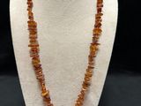 a necklace made of raw amber beads on a white mannequin