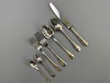 a set of six silverplated forks and spoons on a table