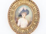 portrait of a woman in a blue hat and white dress in a gold frame