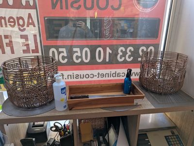 two baskets on a table with a sign in the background