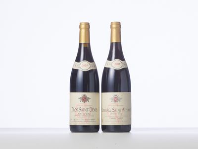 two bottles of wine sitting on top of a table next to each other