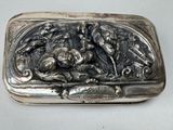 a silver box with a picture of a man and a dog on it