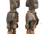 pair of carved wooden figures of a man and a woman