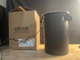 a black trash can next to a brown box on a table