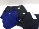 three pairs of black and blue adidas running shorts and a blue adidas tank top